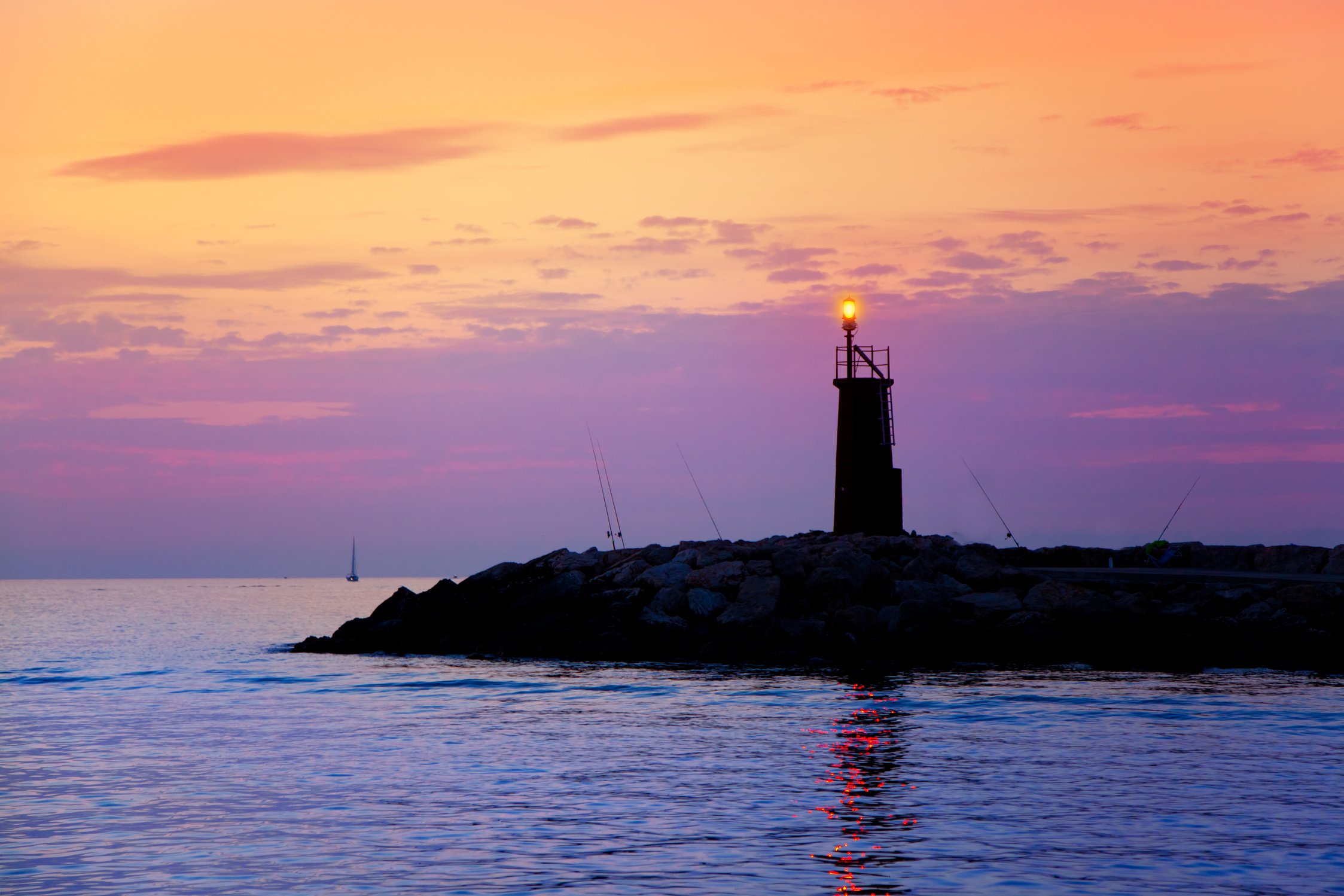 Sunrise Lighthouse Glowing in Blue Purple Sea